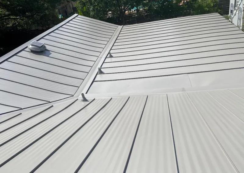 Solar attic fan installed on a metal roof for Roof Ventilation in Grosse Pointe Woods